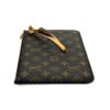 Angled view of the pouch and its gold zip