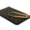Pouch with the vachetta strap laid out beside it