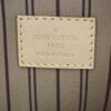 Leather tag reading LOUIS VUITTON PARIS made in France