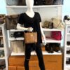 Mannequin holding the shopper with the strap crossbody