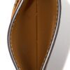 Card case held open showing the tan leather interior
