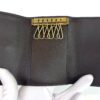 Opened in a gloved hand showing the six hooks and brown leather