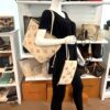 Neverfull MM carried by a mannequin in the boutique with the pouch