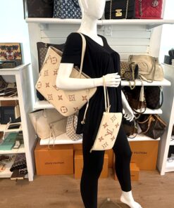Neverfull MM carried by a mannequin in the boutique with the pouch