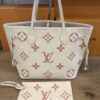 Tote standing with its matching rose monogram pouch in front