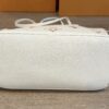Side and base of the tote resting on the floor