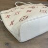 Underside and lower panel of the creme leather tote