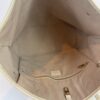 Interior showing the beige lining and side slip pocket