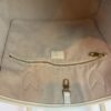Interior zip pocket set into the beige lining