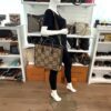 Mannequin holding the tote with the web strap