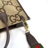 Side of the tote with the strap clip and web