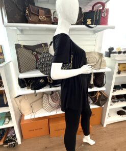 Saddle bag worn crossbody by a mannequin in the boutique