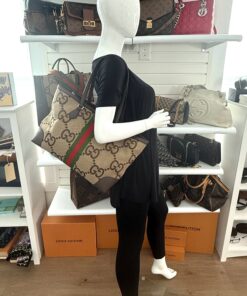 Ophidia tote carried by a mannequin in the boutique