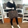 Mannequin holding the tote by its leather handles