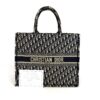 Tote shown with its certificate of authenticity card