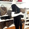 Mannequin holding the Saddle bag by its strap