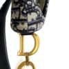 Strap attached to the bag at the gold CD hardware
