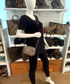 Marmont mini camera bag worn crossbody by a mannequin in the boutique