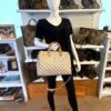 Speedy 30 carried by a mannequin in the boutique with the strap crossbody