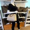 Mannequin holding the Speedy 30 by its rolled vachetta handles