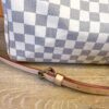 Side of the bag showing the Damier Azur check and shoulder strap