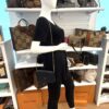 Felicie pochette worn crossbody by a mannequin in the boutique