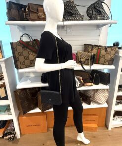 Felicie pochette worn crossbody by a mannequin in the boutique
