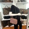 Mannequin holding the bag with the chain doubled