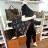 Onthego GM tote carried by a mannequin in the boutique