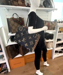 Onthego GM tote carried by a mannequin in the boutique