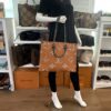 Mannequin holding the tote by the top handles