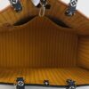 Tote held open showing the full mustard interior