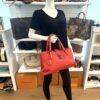 Roma satchel carried on the arm of a mannequin in the boutique