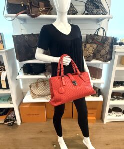 Roma satchel carried on the arm of a mannequin in the boutique