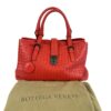 Satchel resting on its original olive Bottega Veneta dust bag