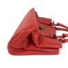 Satchel laid on its side with the rolled handles folded