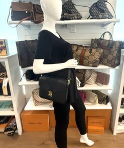 Pochette Metis worn crossbody by a mannequin in the boutique