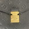 Gold S-lock closure on the embossed monogram leather