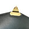 Close up of the gold lock catch on the flap