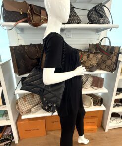 Crush bag worn on the shoulder, shown from behind in the boutique