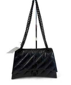 Balenciaga Medium Black Crush Leather Chain Strap Shoulder Bag, hanging from its chain strap with the tag attached