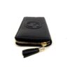 angled view showing the gold zip and leather tassel pull