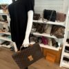 The briefcase held by a mannequin, showing its size in hand