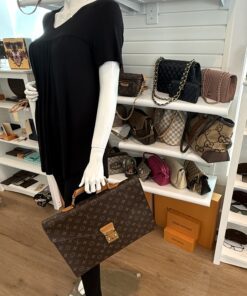 The briefcase held by a mannequin, showing its size in hand