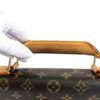 The handle held upright at the brass attachment ring