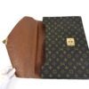 Flap opened, showing the tan leather lining and lock plate