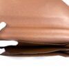 Interior compartments in tan leather, held open