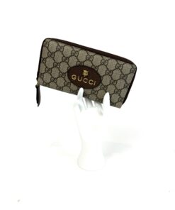 The wallet displayed upright on a white hand stand