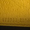 Serial code 473953 2184 stamped in the yellow leather