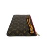 Corner of the pochette with the strap and zip pull